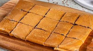 House Chocolate: Tonino crepe cut into bite-sized squares on a wooden board