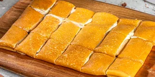 White Chocolate: Tonino crepe cut into bite-sized squares on a wooden board